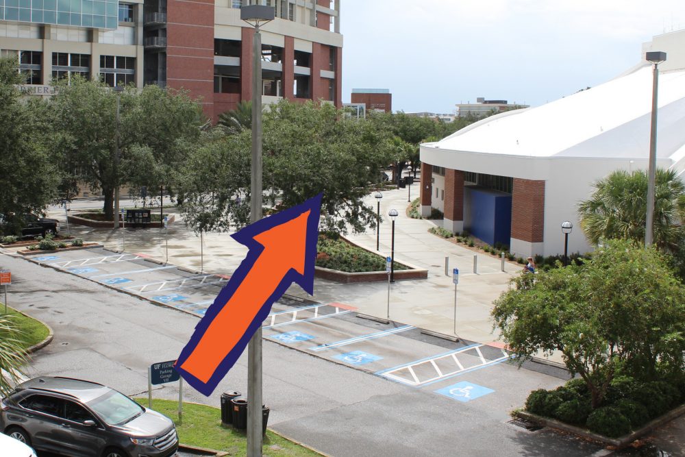 Arrow pointing between the Ben Hill Griffin Stadium & Stephen C. O’Connell Center