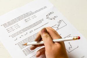 Student with pencil taking multiples choice question test