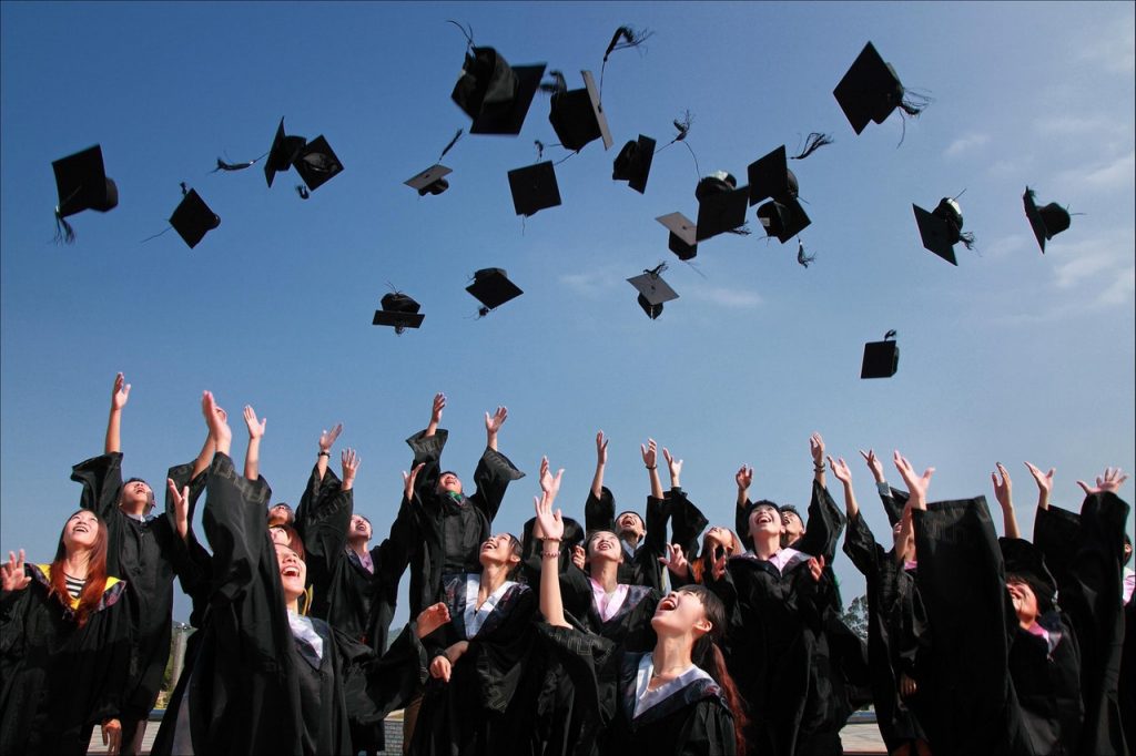 Graduates throwing caps in air