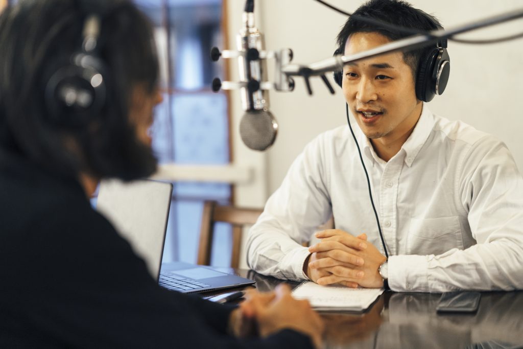 two individuals recording a podcast