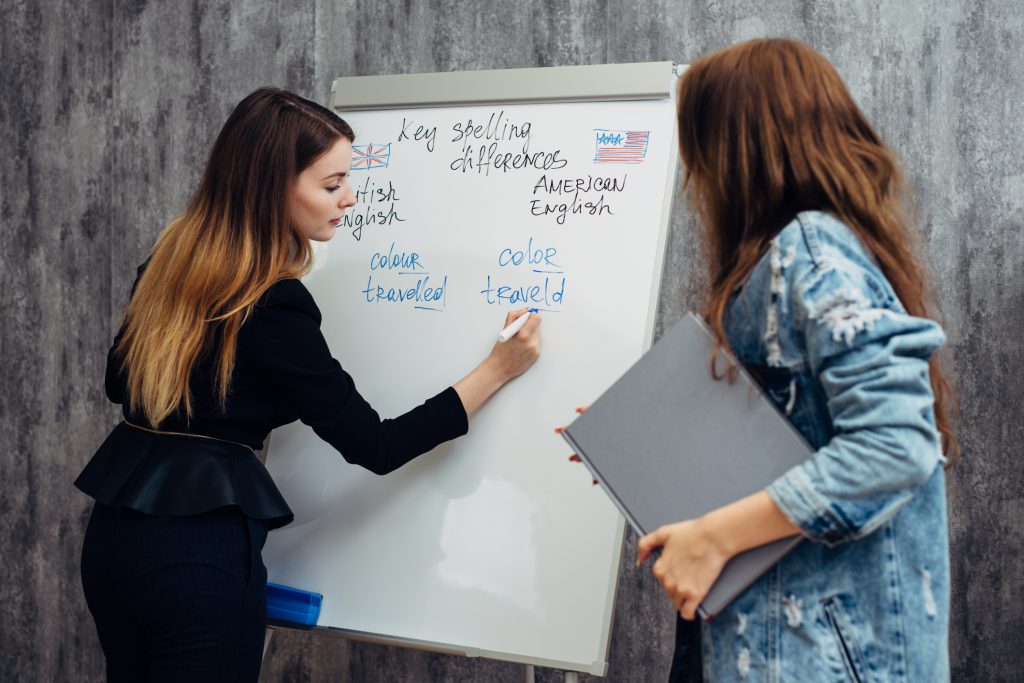 Woman writing on a standing whiteboard