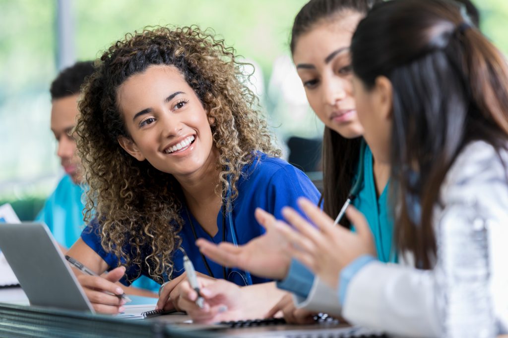 Mentor having a conversation with two mentees