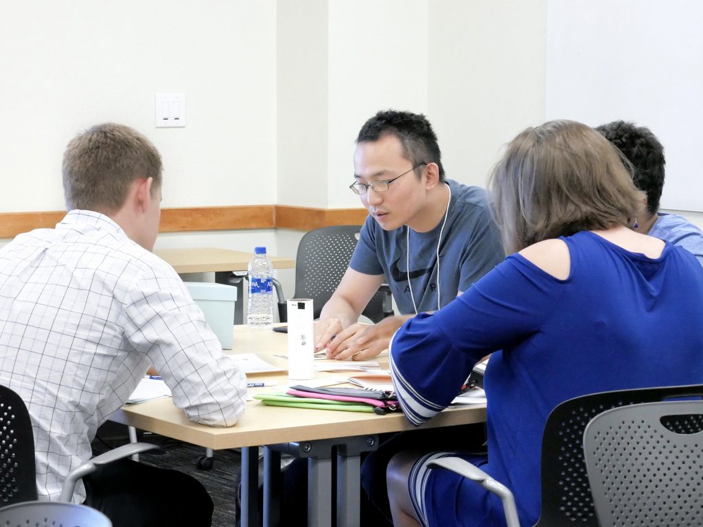 Group of faculty solving a puzzle during a workshop