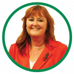 A photo of Jennifer Parker wearing an orange blazer. 